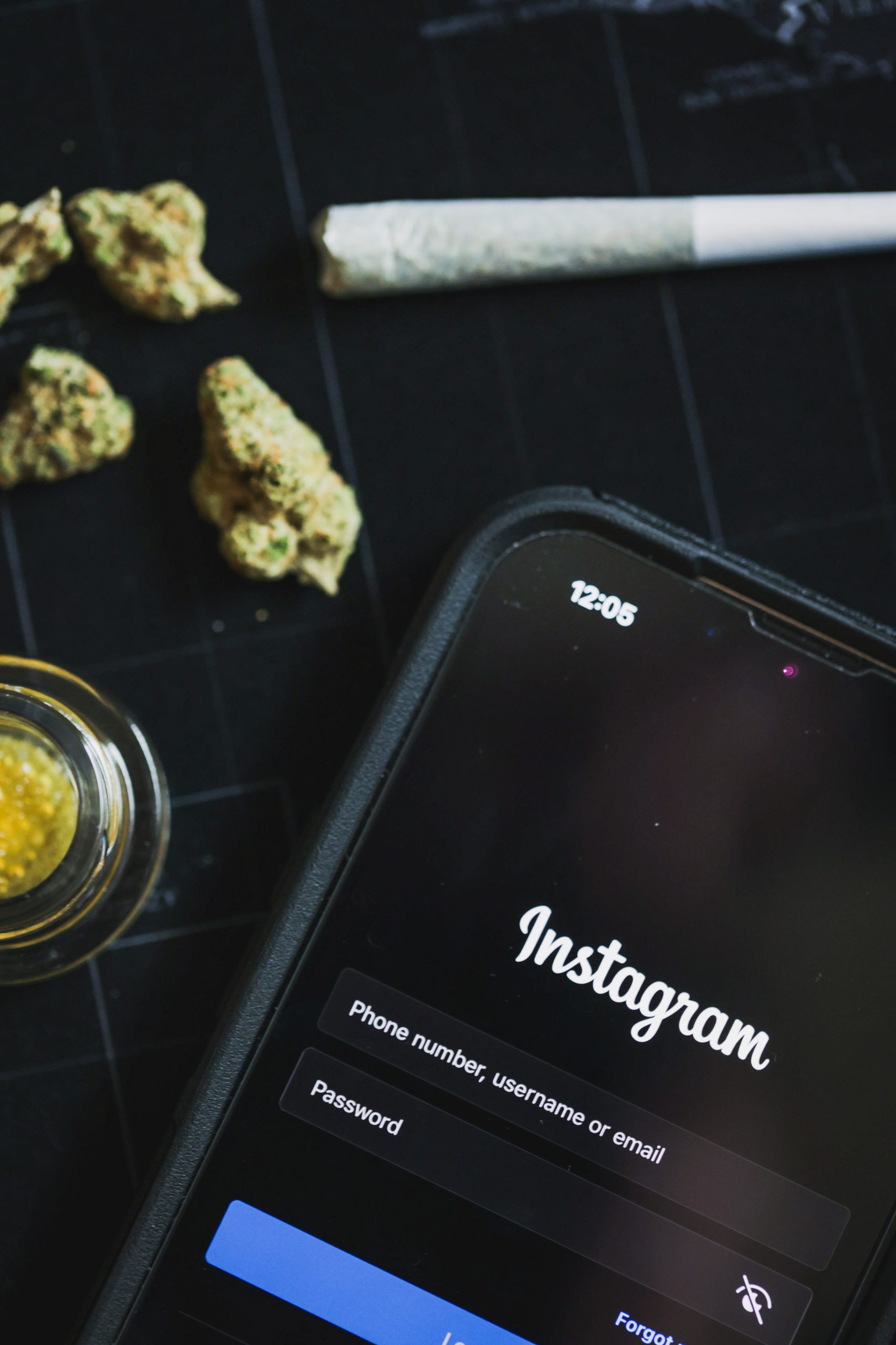 Phone and cannabis products illustrating how to market your cannabis brand with instagram